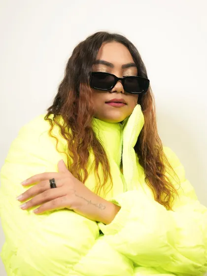 Embrace the serenity of the moment. A portrait in a bright neon jacket, showing a calm and collected side.