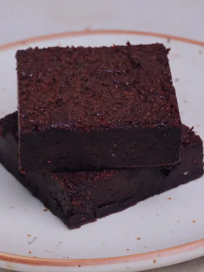 A close-up of our classic dark chocolate brownie. You can see the dense, fudgy texture that we're known for. It's not a cake, it's a proper brownie.