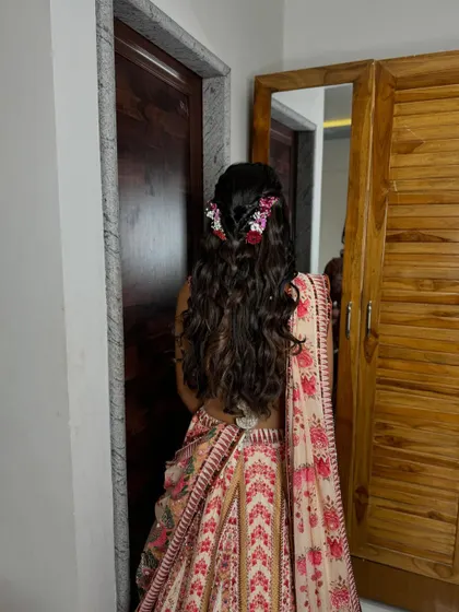 The hairstyle is romantic and whimsical, perfect for a daytime engagement party.
