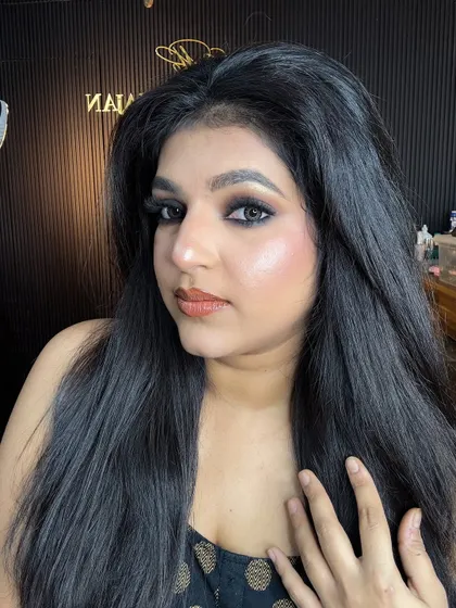 A side profile of the classic smokey eye look, showcasing the beautiful hairstyle and glowing skin.