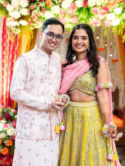 A happy couple portrait from the Mehndi ceremony. The bride's makeup is light and fresh, perfect for a daytime celebration.