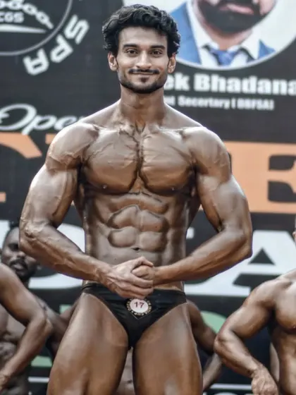 Holding a pose on stage among other competitors. The confidence you see comes from knowing you've done everything possible to be your best.