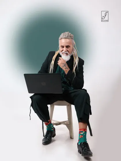 Incorporating a laptop as a prop, this shot blends fashion with a modern, professional narrative.