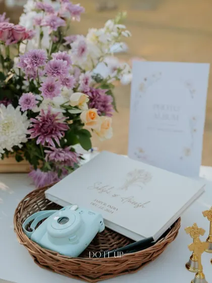 A custom guest book station with a Polaroid camera. This is a wonderful way to capture candid moments and heartfelt messages from loved ones.