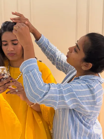 A behind-the-scenes moment of me perfecting the hairstyle. Even the simplest styles require attention to detail to make sure they last.