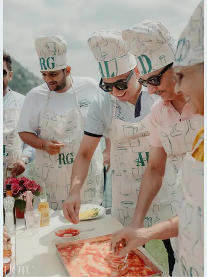 Guests having fun at the DIY pizza party, a perfect way to bond and enjoy the beautiful Lake Como scenery between celebrations.