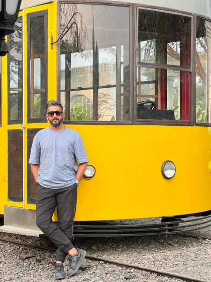 Posing by a cool yellow tram, a great prop I found for a shoot location.