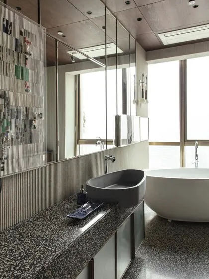 The daughter's bathroom, featured in Elle Decor, showcases our ability to create glamorous yet functional personal spaces. The design uses terrazzo, limestone, and custom lighting to create a serene and stylish retreat.