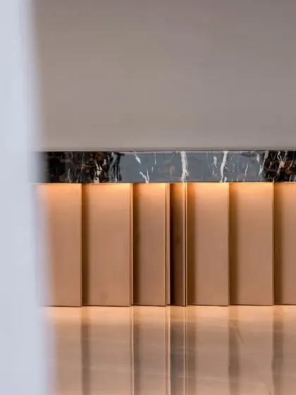 This detail shot of a console in the Mumbai penthouse showcases my belief in subtle luxury. The clean lines of the metallic base, the rich texture of the marble top, and the soft, reflected light create a moment of refined elegance.
