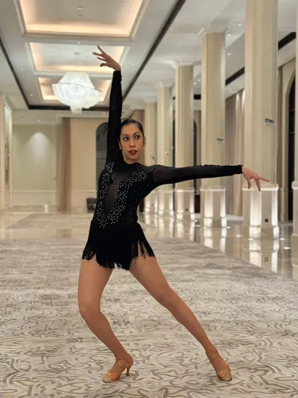A series of photos from a professional performance in Abu Dhabi. These shots capture the different poses, lines, and moments from our polished Salsa duet, highlighting our performance costumes and stage-ready look.