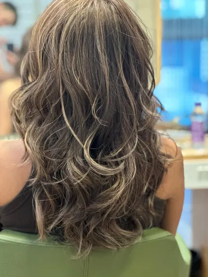 Color and confidence. This transformation from black hair resulted in a beautiful, warm balayage with soft waves that frame the face perfectly.