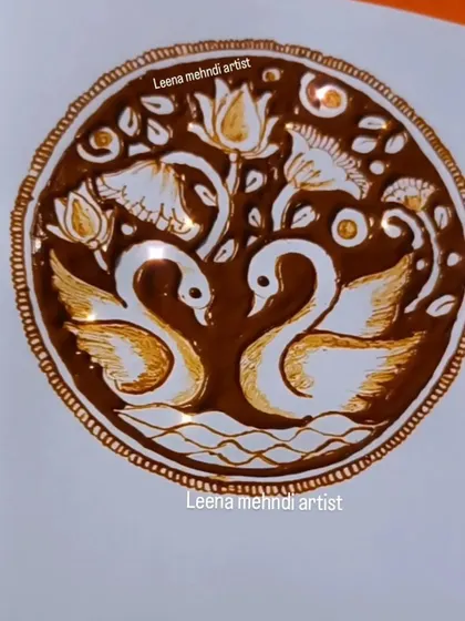 The completed swan mandala, with rich, dark henna creating a beautiful contrast. This design combines figurative work with traditional mandala patterns.