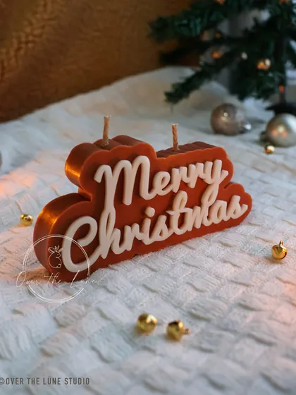 Another angle of the brown 'Merry Christmas' candle, showing off its clean lines and beautiful script.