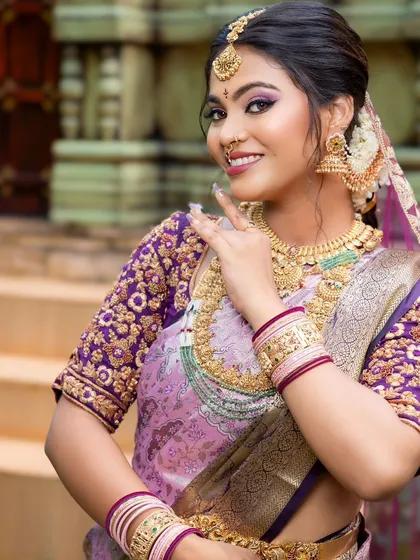 A close-up portrait of the bride, her smile as bright as the jewellery she wears.