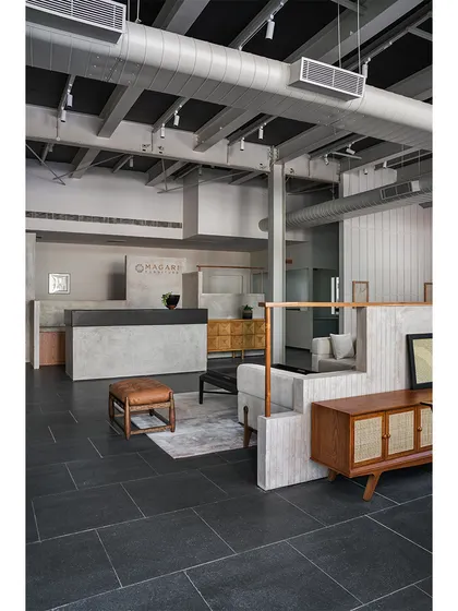 The reception area sets the tone for the showroom. We kept the color palette neutral with raw concrete and dark stone flooring, allowing the finely crafted furniture to take center stage.