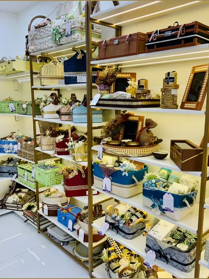 The shelves of our showroom are filled with a diverse range of hamper baskets and boxes in various colors, shapes, and sizes. This display showcases the variety of our packaging options.