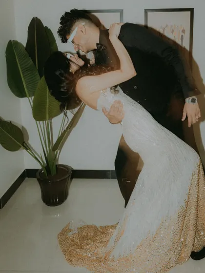 A playful, motion-blurred shot of the groom dipping the bride during their after-party.