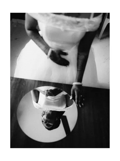 An artistic black and white shot of a bride's reflection, creating a thoughtful and introspective portrait.