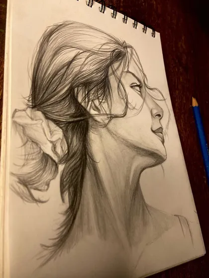A random practice session sketching a woman's profile. I love capturing the way hair flows and the subtle expression on a person's face.