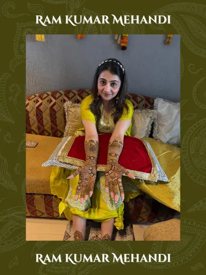 A happy bride proudly displaying her full bridal mehandi on both hands and feet.