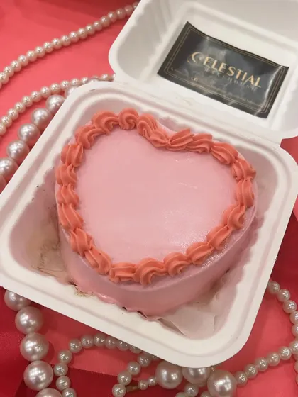 Our pink heart bento cake, surrounded by pearls, ready to be delivered for a sweet celebration.