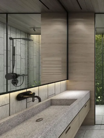 Serenity meets sophistication in this minimalist bathroom. The design features a seamless blend of natural stone, warm wood accents, and sleek black fixtures, with a large mirror reflecting the shower and enhancing the sense of space.