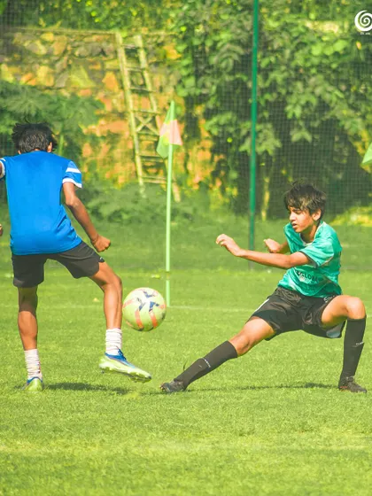 A player lunges to block a pass, showing great defensive effort.