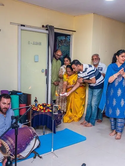 Participants receiving blessings and prasadam at the conclusion of a devotional gathering, a traditional end to our spiritual events.