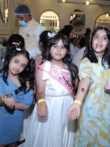 Girls showing their new glittery temporary tattoos, a popular activity at our parties.