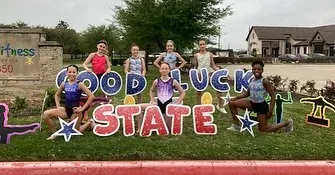 Our Level 7 team posing with their "Good Luck State" sign. The support from their teammates means the world.