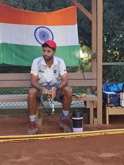 A quiet moment of focus before a match in Portugal, with the Indian flag behind me. Representing the country is the highest honor.