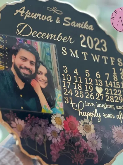 Another angle of the elegant black anniversary calendar frame, showing the depth of the resin and the intricate arrangement of the flowers at the base.