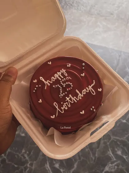 A rich, dark red bento cake for a 25th birthday, with delicate white piping and silver beads.