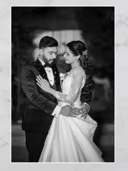 A timeless black and white portrait of the couple. This image has a classic, film-like quality that emphasizes their elegance and romance.