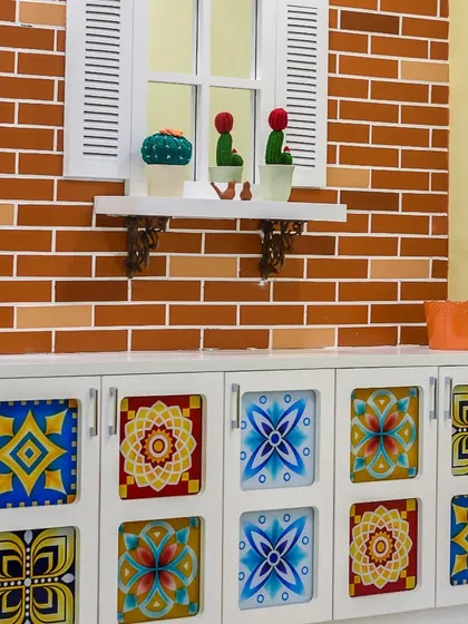 A duplicate of ID 38, this crockery unit with colorful tiled doors and a faux brick wall is a perfect example of how we incorporate unique and personalized decor elements.