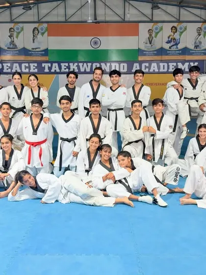 A candid moment with our Peace Taekwondo family. The smiles and relaxed poses show the genuine camaraderie that exists among our athletes after a hard training session.