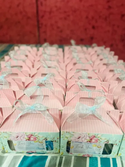 A front view of the baby shower return gift hampers. The floral design and custom sticker make these a sweet and memorable favor for guests.