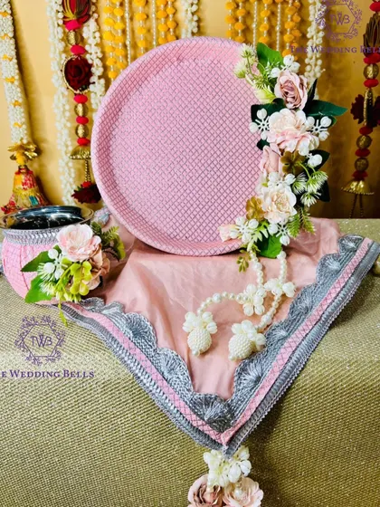 This pastel pink floral thali set is soft, elegant, and timeless. The delicate flowers and pearl details are perfect for a modern yet traditional look.