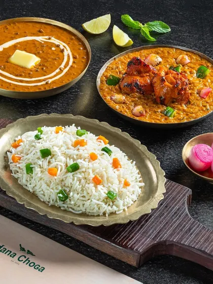 A non-vegetarian combo of Dal Makhani, Chicken Tikka Masala, and vegetable rice.