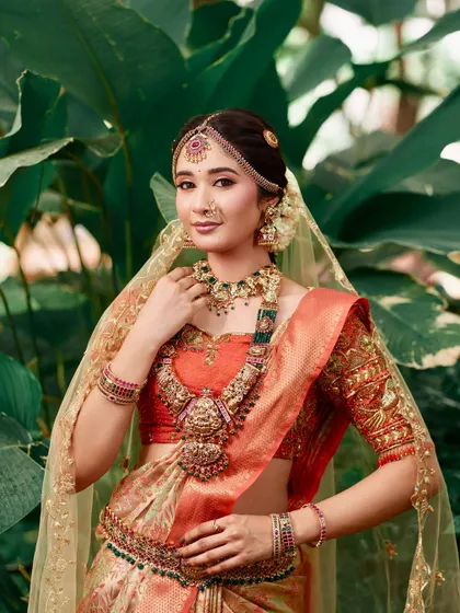 A duplicate of 47, showing the same beautiful details of the temple jewellery set against the lush green background.