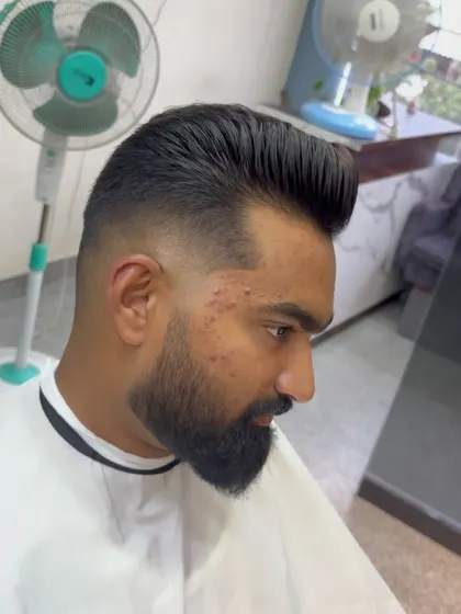 A high-volume pompadour with a skin fade.