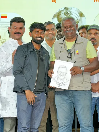A happy moment presenting a sketch to director and producer T.S. Nagabharana. His smile shows the simple joy that a piece of art can bring.