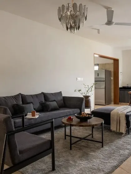 The open-plan informal living and dining area in the penthouse, designed as a functional and warm family space with plenty of natural light.