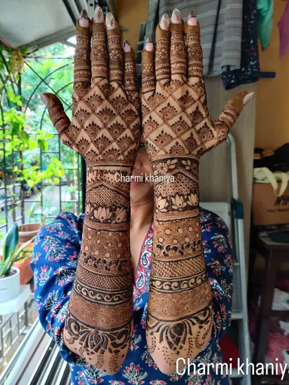 Another look at a beautiful bridal mehendi for the back of the hands. The design is filled with intricate checks, lotus motifs, and traditional bands for a classic and timeless feel.