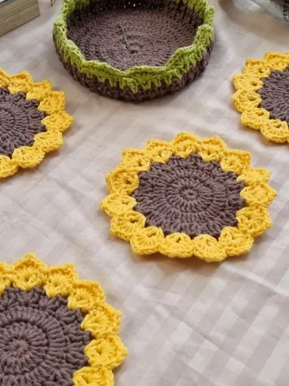 A top-down view of our sunflower coasters and the matching basket. You can see the detailed stitch work that goes into each piece.