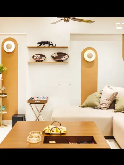 A close-up of the seating area, showing the L-shaped sofa with plush cushions and the unique wall niches with integrated lighting that serve as decorative elements.