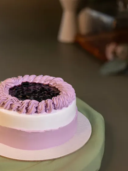 This is my Lemon Blueberry bento cake, with a lovely lavender-hued frosting. The center is filled with a sweet and tangy blueberry compote that cuts through the richness.