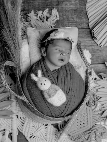 A boho dream in black and white. The rich textures of the macrame, basket, and dried foliage create a stunning, artistic composition in this monochrome shot.