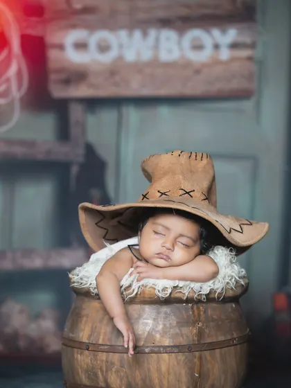 This sleepy cowboy is using his hat as a pillow, dreaming of his next adventure.