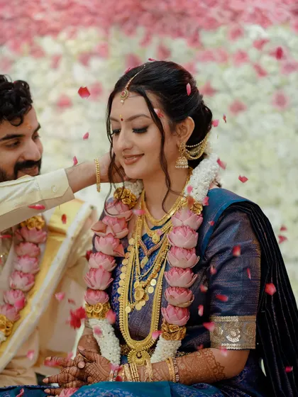 A candid moment with falling petals. Her makeup remains flawless, and she looks like a dream.